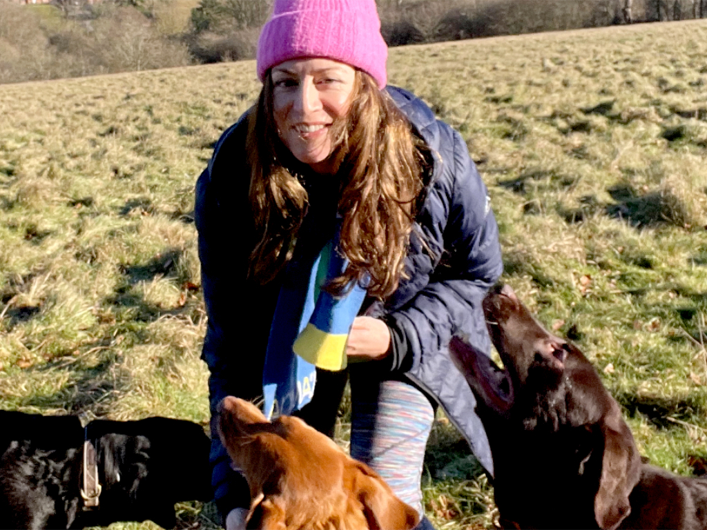 Dog walker Lucy Melzer playing with dogs